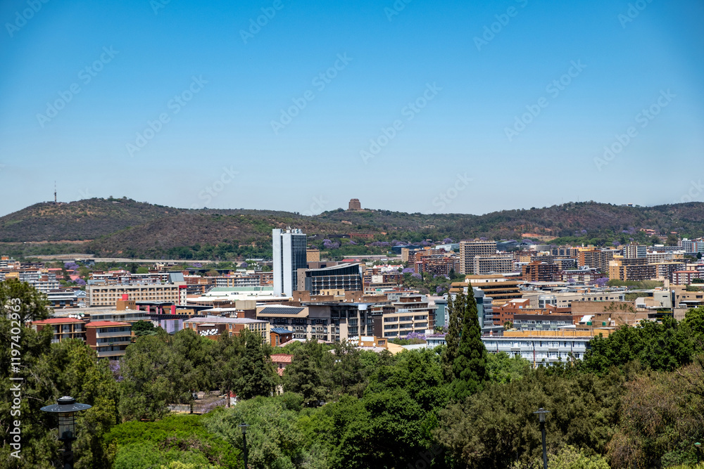 Pretoria city view from Union Buildings gardens, high buildings and blooming jacaranda trees. South Africa. Pretoria city view from Union Buildings gardens, high buildings and blooming jacaranda trees. South Africa.