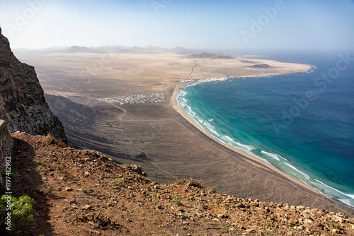 Overzicht vanaf de vulkanische roten op La Caleta de Famara, surfersparadijs op Lanzarote, Canarische eilanden photo