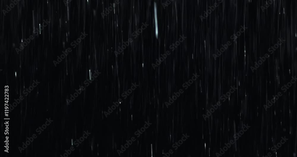 4K high-speed angled heavy rainstorm on a black surface, dynamic splashing of raindrops. High-end rain closeup VFX insert, a powerful weather element, showcasing the intense realism of the rain.	