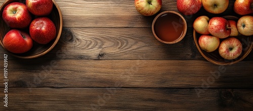 Red apples in wooden bowls on a rustic table with apple juice in a small cup and ample copy space for text insertion photo