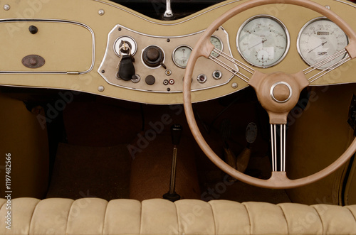 Dashboard layout of an old 1940s sportscar. Instrumentation and steering wheel.
