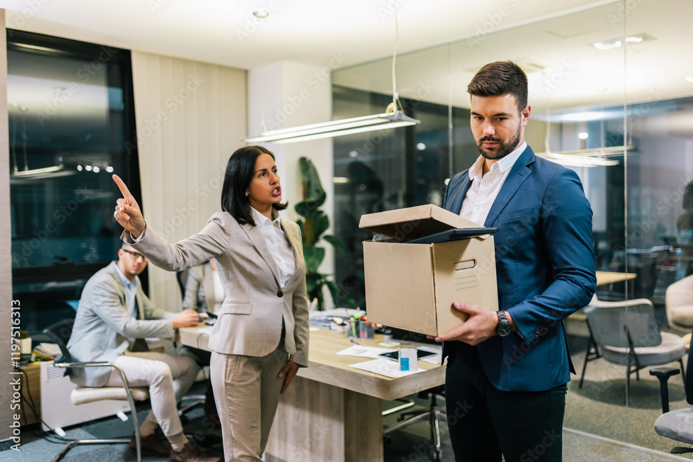 Obraz premium Businessman got fired from his job. Taking box with his personal stuff from the office.