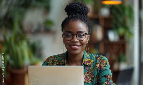 young black woman working on laptop,  work from home, remote worker / digital nomad	