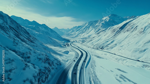 Aerial View of Snowy Mountain Roads Winding Through Majestic Winter Landscapes