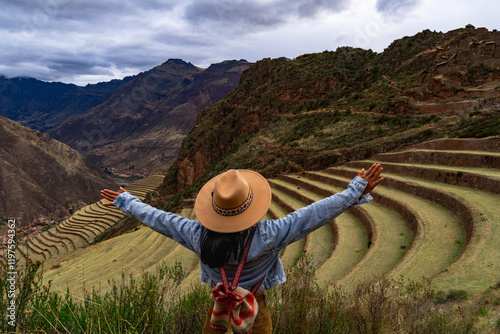 Latin tourist looking at the terraces of Pisac, Pisac archaeological complex in Cusco photo