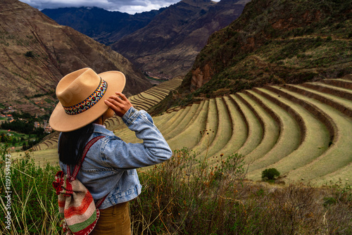 Fotografie Latin tourist looking at the terraces of Pisac, Pisac archaeological complex in