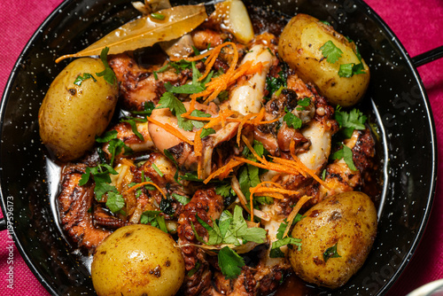 Traditional Portuguese dish, Polvo à Lagareiro, served in a rustic restaurant setting. Grilled octopus with potatoes, garlic, and olive oil, embodying authentic Mediterranean flavors.