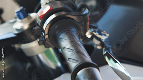 Close-up of a sport motorcycle handlebar with textured grip.