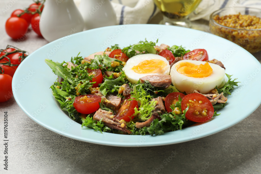 Delicious fresh tuna salad on grey textured table, closeup Delicious fresh tuna salad on grey textured table, closeup