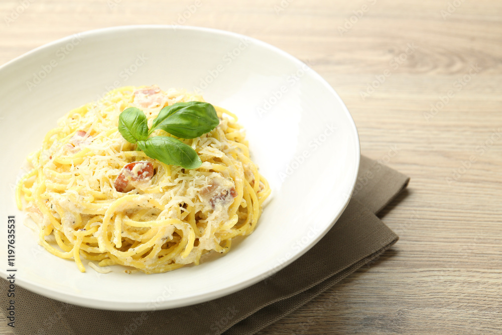 Delicious pasta Carbonara in bowl on wooden table, closeup Delicious pasta Carbonara in bowl on wooden table, closeup