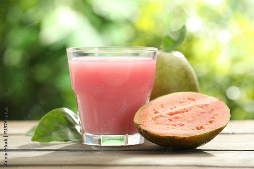 Refreshing guava juice and fresh fruits on wooden table, closeup Refreshing guava juice and fresh fruits on wooden table, closeup