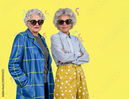 Portrait of two gray-haired elderly women dressed in fashionable bright clothes