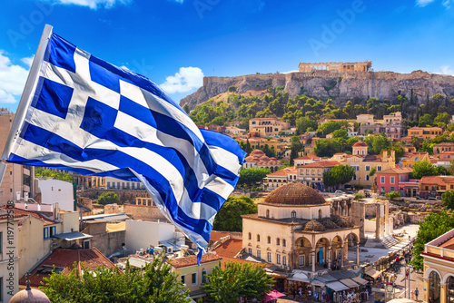 Fototapeta Naklejka Na Ścianę i Meble -  Skyline of Athens with Monastiraki square and Acropolis hill with Greek flag. Athens, Greece.