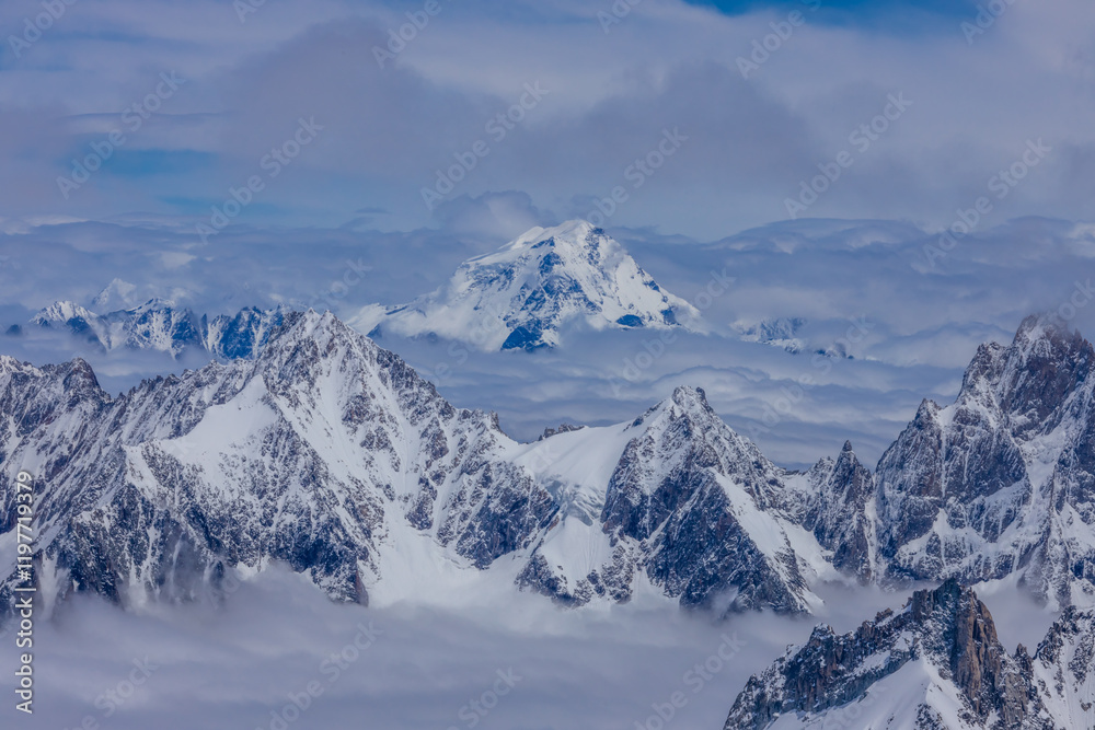 View of snow mountain glaciers at the high altitude in the Alps. Stunning mountain landscape with high snow peaks and summits of Mont Blanc mountain range from Aiguille du Midi summit View of snow mountain glaciers at the high altitude in the Alps. Stunning mountain landscape with high snow peaks and summits of Mont Blanc mountain range from Aiguille du Midi summit