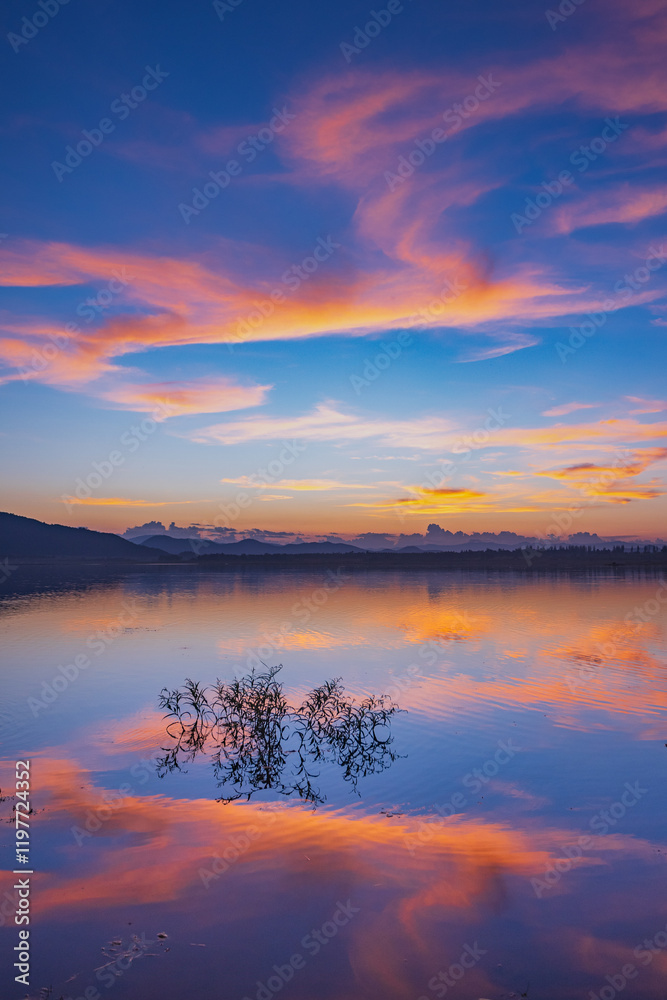 custom made wallpaper toronto digitalLandscape of mountains and lake at sunset and clouds reflected in the water.