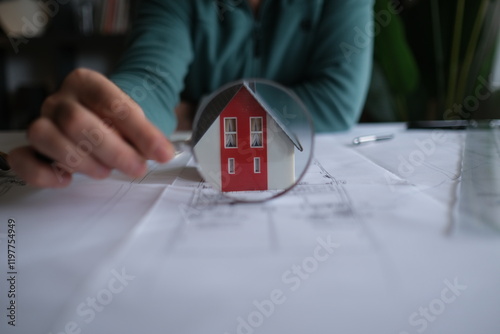 Architect man holding pencil working with laptop and blueprints for architectural plan, engineer sketching a construction project concept.