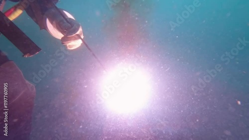 Commercial diver cutting steel underwater close up