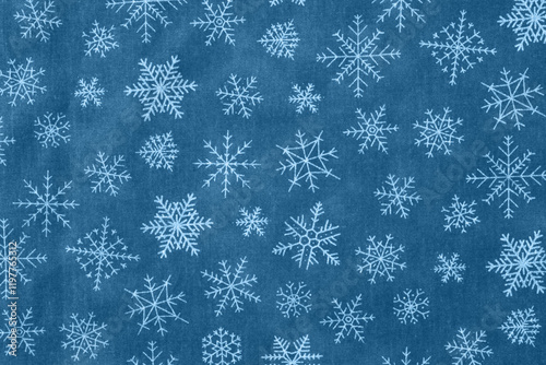 A festive background with snowflakes on a blue wintery pattern. Perfect for holiday designs and seasonal projects