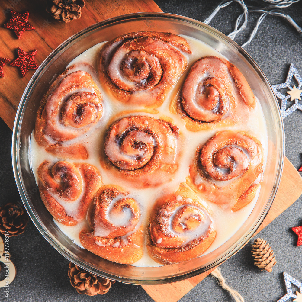 Cinnamon Rolls brioches or cinnamon rolls with icing sugar and cream cheese - decorated for Christmas