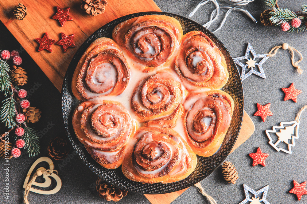 Cinnamon Rolls brioches or cinnamon rolls with icing sugar and cream cheese - decorated for Christmas