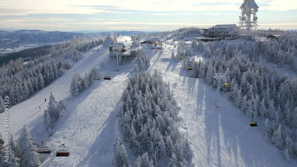 Aerial view of snowy ski slopes with chairlifts on a snowy mountain hill Aerial view of snowy ski slopes with chairlifts on a snowy mountain hill