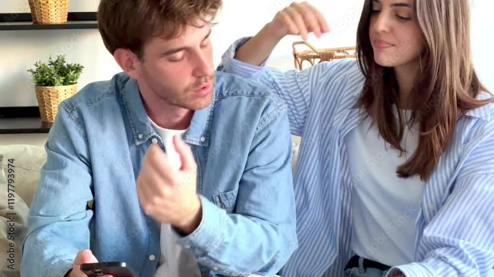 A couple sitting on a couch, their faces filled with sadness as they realize they have lost money on an online betting platform, showing the impact of their gambling mistake