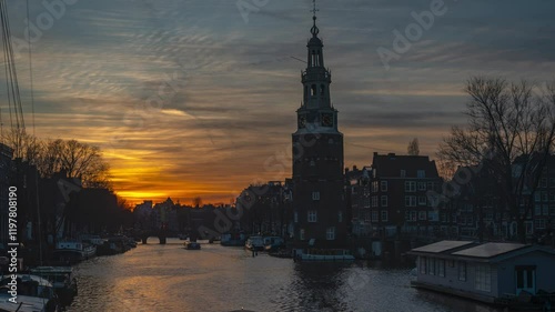 Timelapse at the canals of Amsterdam with a view on historical montelbaan tower by sunset photo