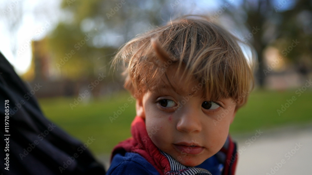 Pensive little baby boy on stroller outside. Contemplative child toddler strolling Pensive little baby boy on stroller outside. Contemplative child toddler strolling