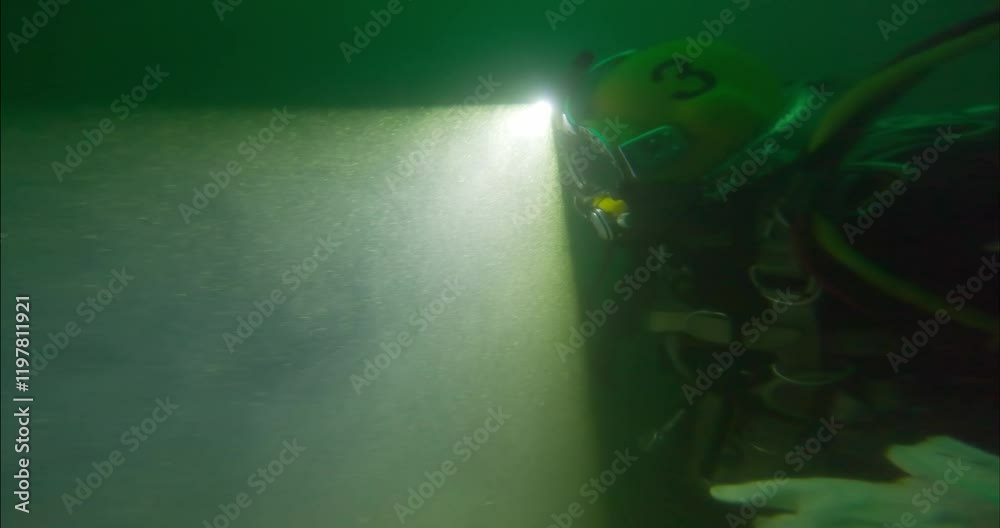 Commercial diver using headlight to navigate closeup