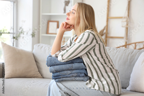 Young woman with folded jea...