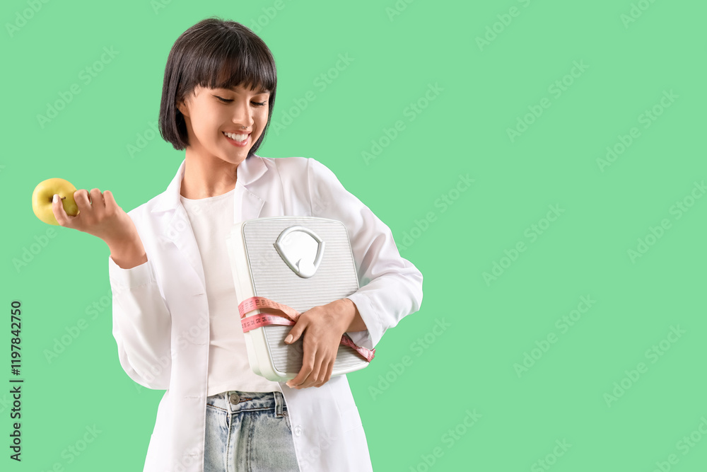 Female nutritionist with apple and weight scales on green background. Diet concept Female nutritionist with apple and weight scales on green background. Diet concept