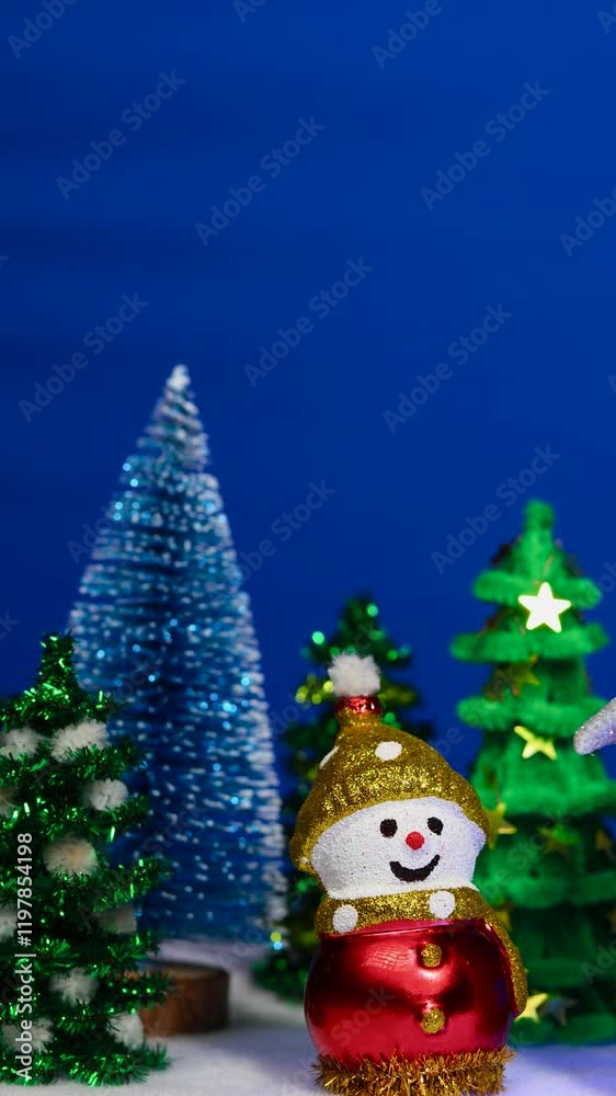 On a blue background near green fir trees there is a snowman On a blue background near green fir trees there is a snowman