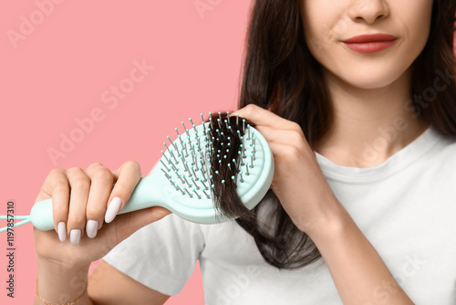 Young woman brushing her ha...