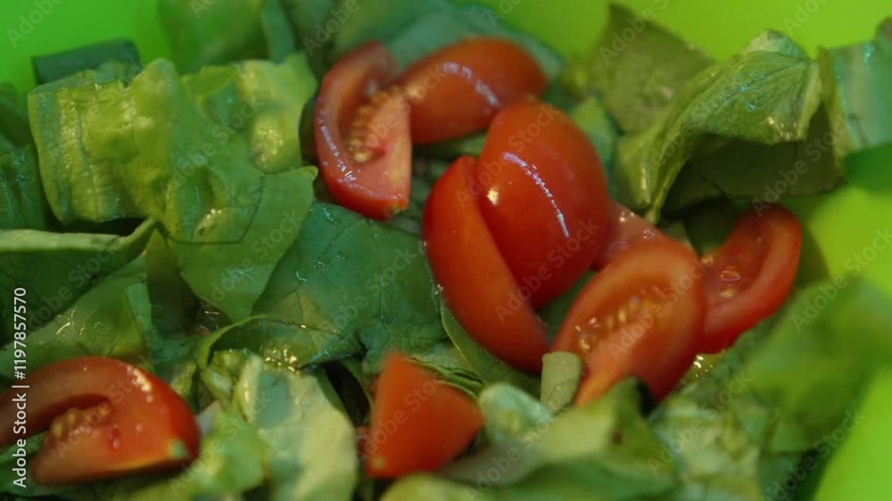Tomatoes being dropped onto salad in bowl slow-motion 4k Tomatoes being dropped onto salad in bowl slow-motion 4k