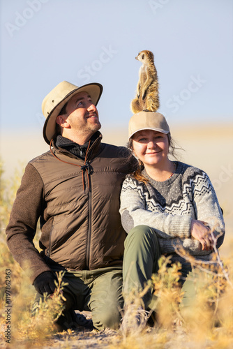 Photography Couple with meerkat on safari.