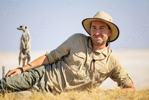 Photography Man on safari with meerkat.