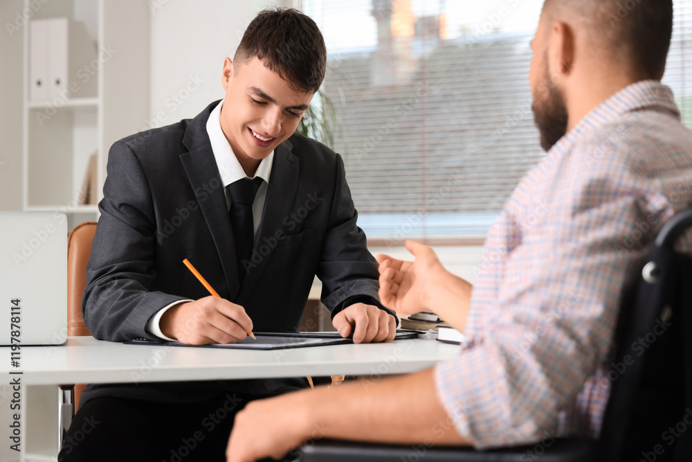 Young lawyer working with man in wheelchair at office Young lawyer working with man in wheelchair at office