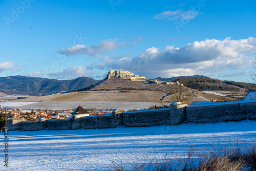 Panoramic winter view of Spis Castle in Slovakia, one of Central Europe's largest medieval castles, dates back to the 12th century. photo