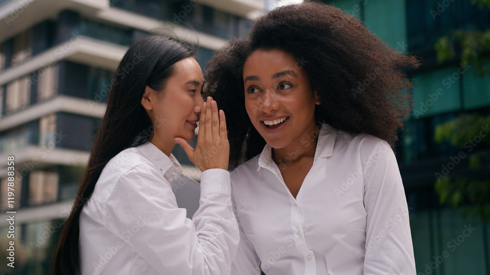 Obraz premium Asian Korean Chinese African American women businesswomen whisper secret gossip laughter colleagues coworkers workers girls females conversation business chatting news talk friendship fun enjoy city