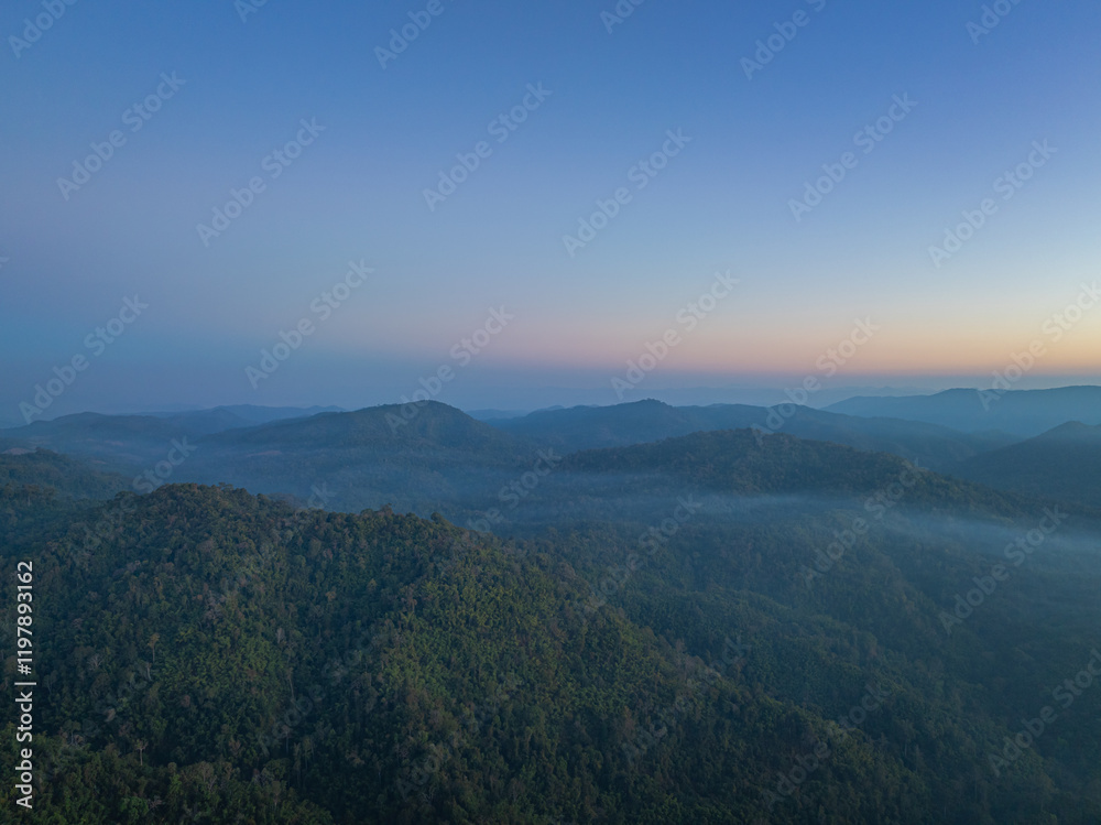 Aerial View of beautiful sunrise above the mist in the valley..There is a sweet sky on the horizon caused by the radiant light of the sun..colorful sky of sunrise Aerial View of beautiful sunrise above the mist in the valley..There is a sweet sky on the horizon caused by the radiant light of the sun..colorful sky of sunrise