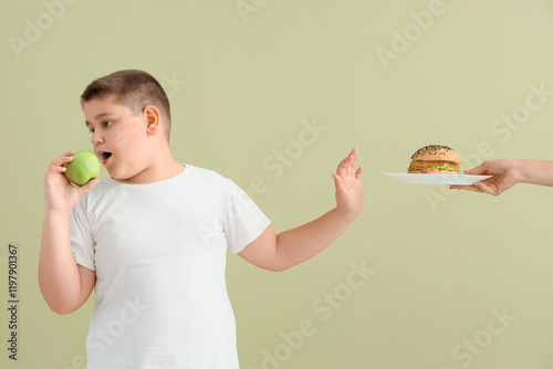 Overweight boy with apple r...