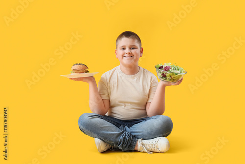 Overweight boy with burger ...