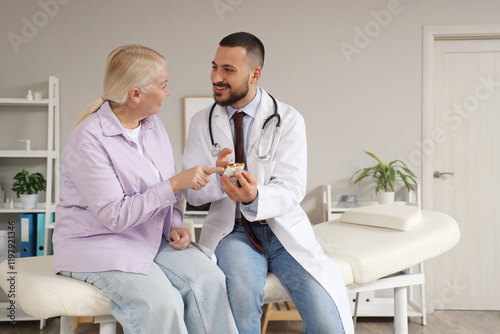 Male doctor with mature wom...