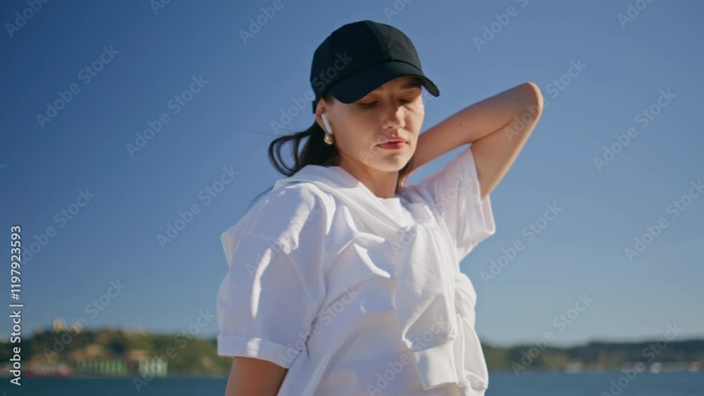 Fit girl warming muscles at morning sport training on quay closeup. Young woman Fit girl warming muscles at morning sport training on quay closeup. Young woman