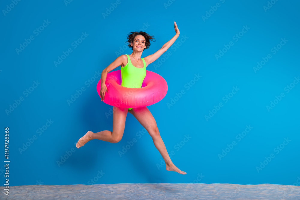 Cheerful Young Woman Jumping With Inflatable Tube Against Blue Background Depicting Summer Joy and Poolside Fun Cheerful Young Woman Jumping With Inflatable Tube Against Blue Background Depicting Summer Joy and Poolside Fun