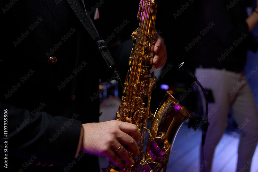 Fototapeta premium An Elegant and Talented Saxophonist Skillfully Playing a Stunning Golden Saxophone