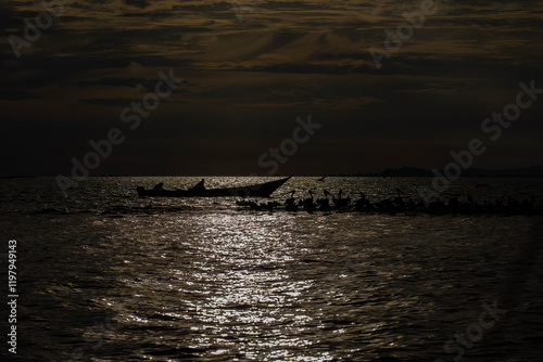 Sunset with fishermen on Lake Victoria photo