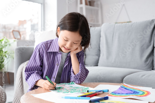 Cute Asian girl drawing on ...