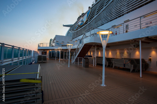Cruise ship deck lit by evening lights