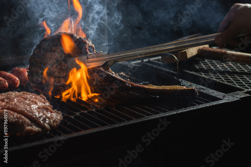 Obraz na płótnie Beef steak on the grill with smoke and flames. w salonie